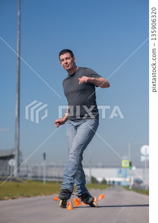 A Caucasian man rollerblades around the slalom course. A Caucasian man rollerblades around the slalom course. 135906320