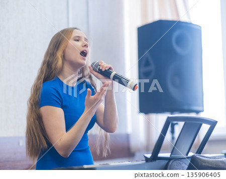 Caucasian woman singing into microphone. Caucasian woman singing into microphone. 135906405