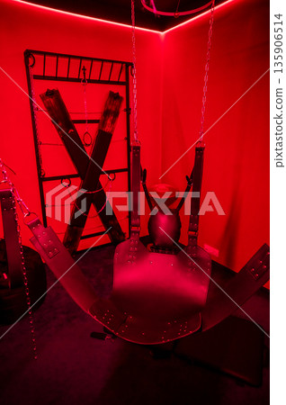 Sex swing in red light. BDSM equipment. Sex swing in red light. BDSM equipment. 135906514