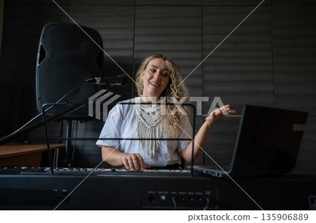 Caucasian woman teaches online music lesson..  135906889