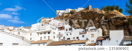 Unique whitewashed village built into dramatic rock formations, offers one of Andalusia most picturesque sights in Setenil de las Bodegas, Spain Unique whitewashed village built into dramatic rock formations, offers one of Andalusia most picturesque sights in Setenil de las Bodegas, Spain 135906901