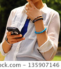 A woman thinking with a smartphone 135907146
