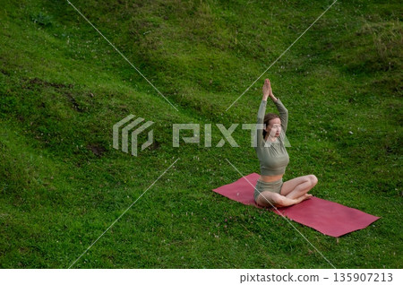 Caucasian woman doing yoga outdoors.  135907213