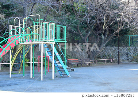 A park with a retro Showa-era atmosphere featuring slides and jungle gyms 135907285