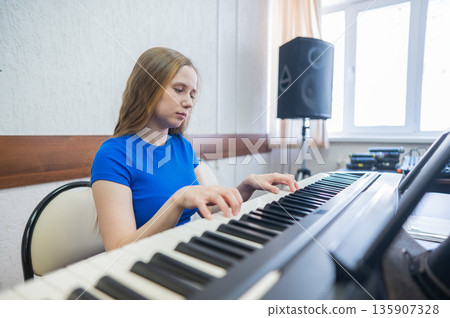Caucasian woman playing electric piano. Caucasian woman playing electric piano. 135907328