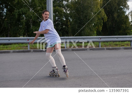 Caucasian woman in shorts roller skating.  135907391