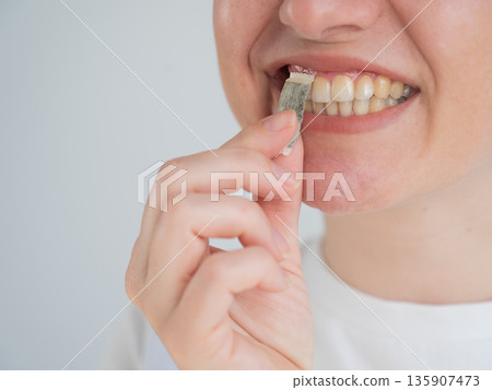 A woman uses chewing tobacco. A woman uses chewing tobacco. 135907473