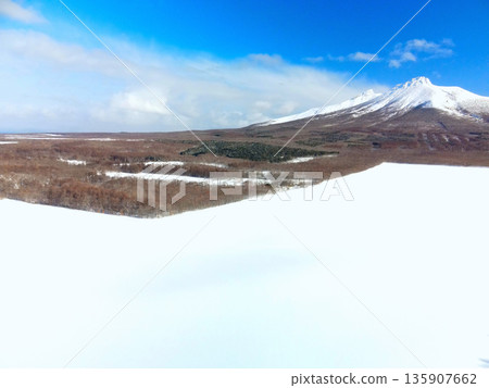 Aerial view of snowy fields and Mt. Komagatake in Mori Town, Hokkaido in winter Aerial view of snowy fields and Mt. Komagatake in Mori Town, Hokkaido in winter 135907662