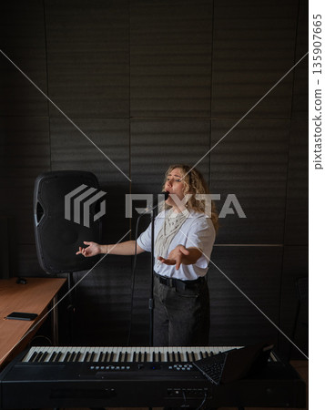 Caucasian woman singing into microphone in music studio. Caucasian woman singing into microphone in music studio. 135907665