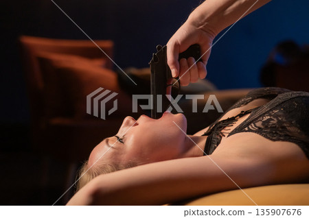 A Caucasian woman lies with a gun in her mouth. Role-playing games. 135907676