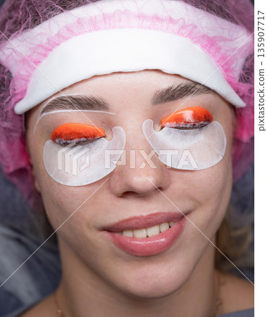 Caucasian woman undergoing eyelash lamination procedure. top view. Caucasian woman undergoing eyelash lamination procedure. top view. 135907717