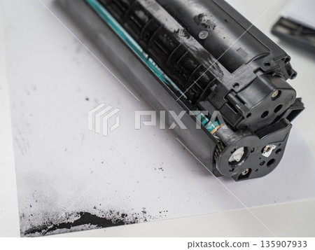 Broken laser printer cartridge on white background.  135907933