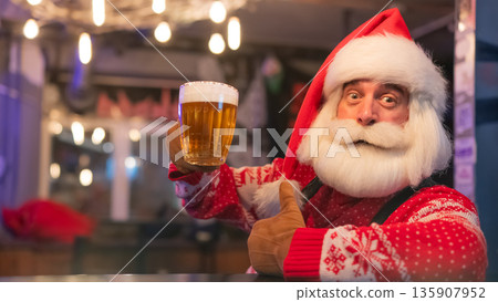Santa Claus drinking beer at a bar. Santa Claus drinking beer at a bar. 135907952