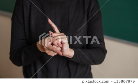 Woman showing the word translator in Russian sign language.  135907979