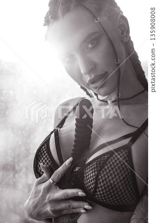 Caucasian woman holding a black dildo. Caucasian woman holding a black dildo. 135908008