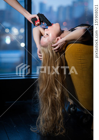 A Caucasian woman lies with a gun in her mouth. Role-playing games. A Caucasian woman lies with a gun in her mouth. Role-playing games. 135908021