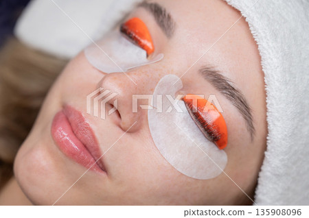 Caucasian woman undergoing eyelash lamination procedure. Caucasian woman undergoing eyelash lamination procedure. 135908096