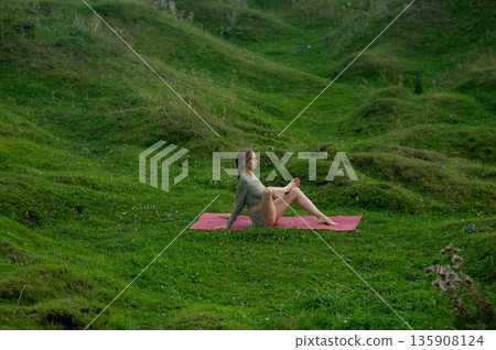Caucasian woman doing yoga outdoors.  135908124