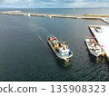 Aerial view of fishing boats returning to port at Washinoki Fishing Port in Mori Town, Hokkaido in winter 135908323