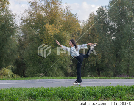 Caucasian woman roller skating in park. Caucasian woman roller skating in park. 135908388