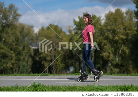 Caucasian woman roller skating in park.  135908393