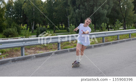 Caucasian woman rollerblading fast on road. Caucasian woman rollerblading fast on road. 135908396