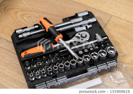 A well-organized professional tool kit featuring a variety of wrenches, sockets, and screwdriver bits for efficient home repairs and maintenance tasks A well-organized professional tool kit featuring a variety of wrenches, sockets, and screwdriver bits for efficient home repairs and maintenance tasks 135908628