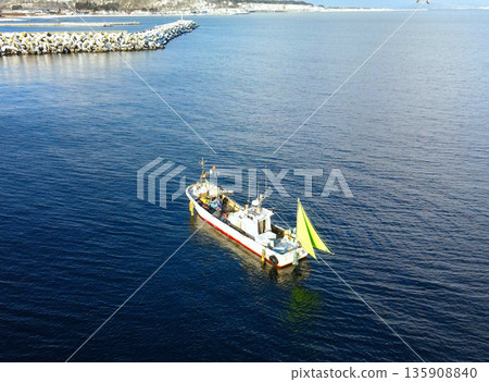 Aerial view of fishing boats fishing in Yakumo Town, Hokkaido in winter 135908840