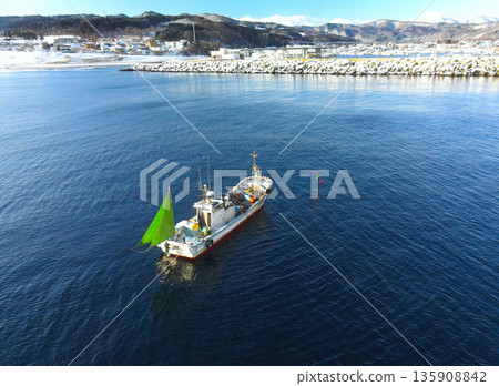 Aerial view of fishing boats fishing in Yakumo Town, Hokkaido in winter 135908842