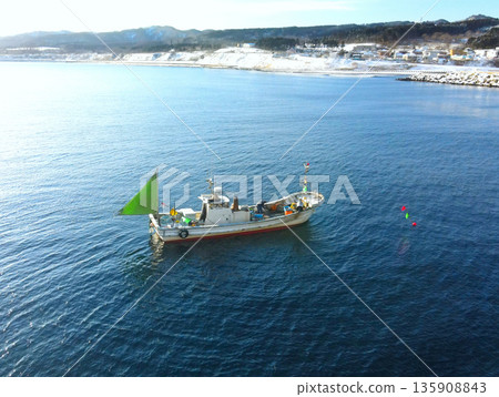 Aerial view of fishing boats fishing in Yakumo Town, Hokkaido in winter 135908843