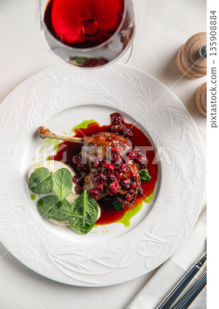 Duck confit leg with berry sauce Duck confit leg with berry sauce 135908884