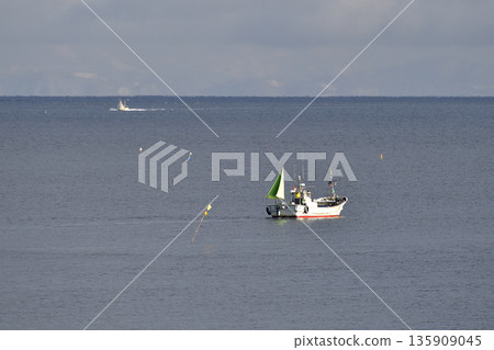 Photographing a fishing boat operating off the coast of Yakumo Town, Hokkaido in winter 135909045