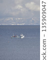 Photographing a fishing boat operating off the coast of Yakumo Town, Hokkaido in winter 135909047