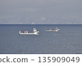 Photographing a fishing boat operating off the coast of Yakumo Town, Hokkaido in winter 135909049