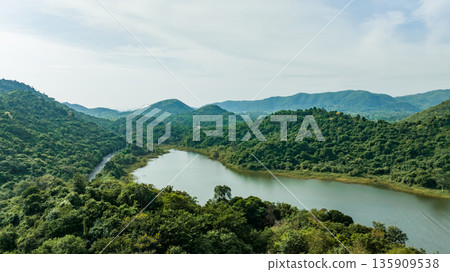Kaeng Krachan dam with lake view and many green moutain, blue sky background. Kaeng Krachan Dam national park, Phetchaburi province, Thailand in aerial view from drone. 135909538