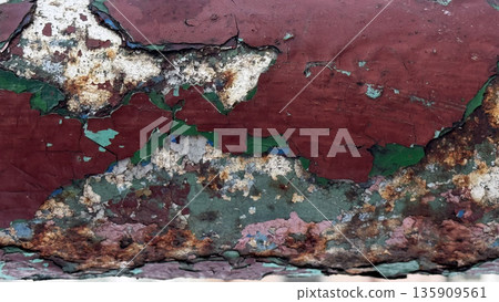 Textured Close-Up of Weathered and Peeling Paint Surface 135909561