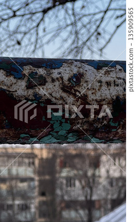 Close-Up of Weathered Metal with Peeling Paint in Urban Setting 135909565