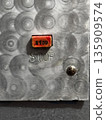 Industrial Stop Button on Metal Panel for Safety Applications 135909574