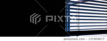 Wide interior banner image of horizontal window blinds with daylight and shadow lines, with large black copy space. Wide interior banner image of horizontal window blinds with daylight and shadow lines, with large black copy space. 135909677