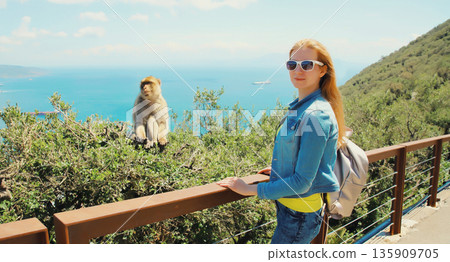 Woman tourist and macaque monkey. Gibraltar Woman tourist and macaque monkey. Gibraltar 135909705
