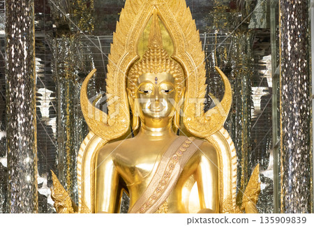close up of golden Buddha statue is a stunning sight to behold. The intricate details and craftsmanship of the sculpture are clearly visible, showcasing the skill and talent of artist who created it. close up of golden Buddha statue is a stunning sight to behold. The intricate details and craftsmanship of the sculpture are clearly visible, showcasing the skill and talent of artist who created it. 135909839