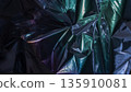 Abstract iridescent metallic foil texture with dark reflective folds 135910081