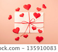 Love letter envelope with red hearts and ribbon 135910083