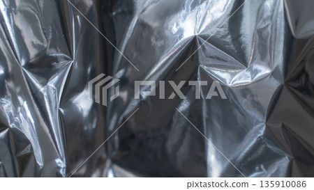 Smooth dark metallic foil texture with glossy reflective surface 135910086