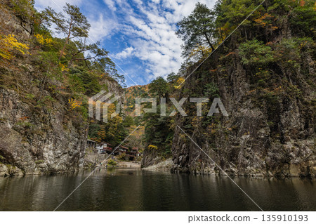 View of the rock cliffs and autumn foliage from the ferry at Kurofuchi in Sandankyo, a gorge in Akiota Town, Yamagata County, Hiroshima Prefecture, Japan 135910193