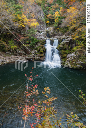 Sandankyo Gorge, a gorge in Akiota Town, Yamagata County, Hiroshima Prefecture, Japan, with its three-tiered waterfall and autumn foliage Sandankyo Gorge, a gorge in Akiota Town, Yamagata County, Hiroshima Prefecture, Japan, with its three-tiered waterfall and autumn foliage 135910226