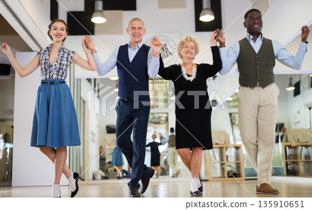 Men and women swing dancers standing in row 135910651