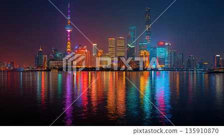 A panorama of a modern high-tech city at night with reflection in the water 135910870