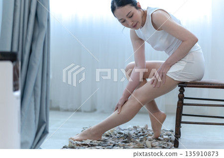 Woman doing leg massage Woman doing leg massage 135910873