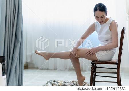 Woman doing leg massage Woman doing leg massage 135910881